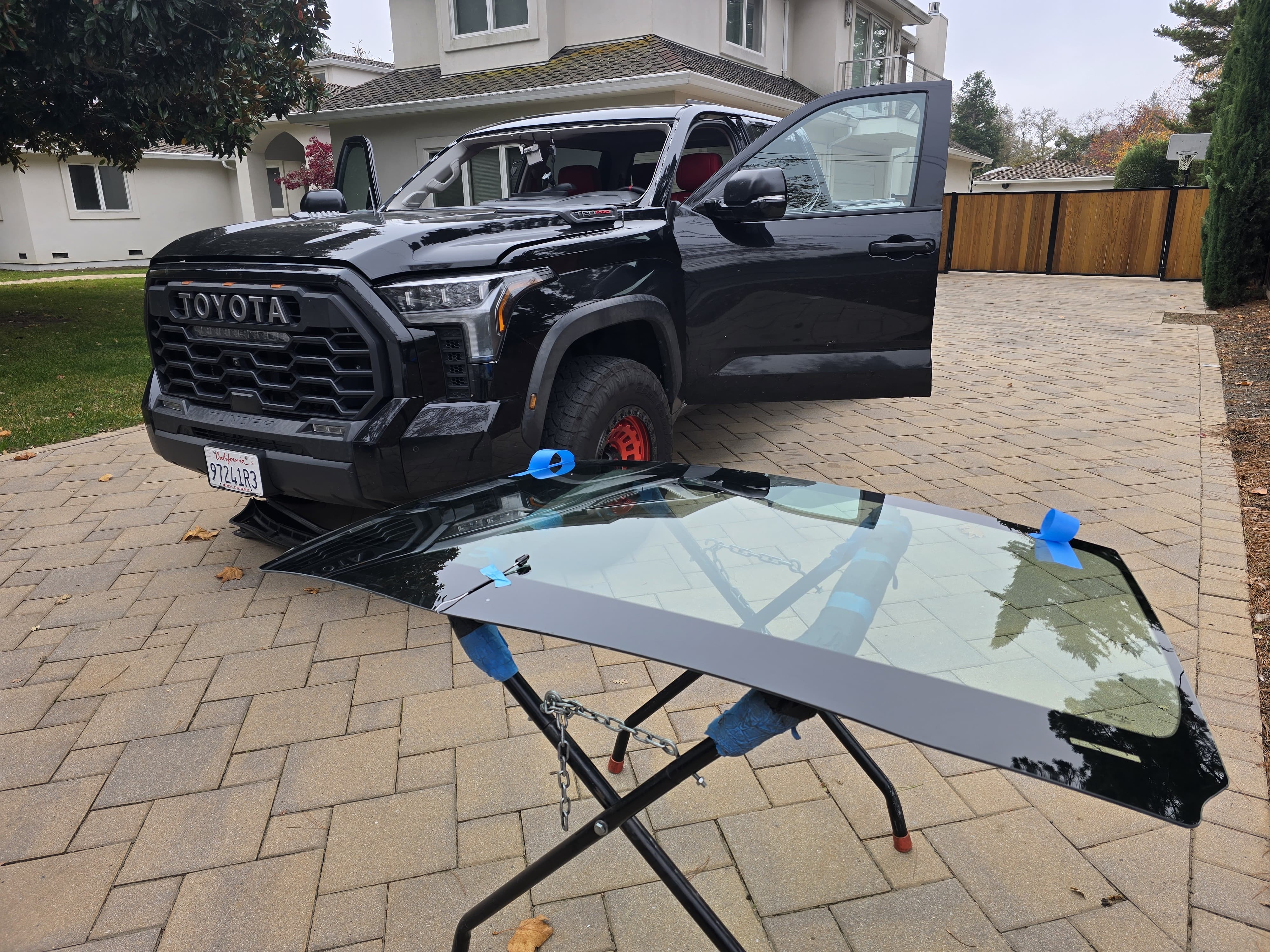 Black Toyota Tundra TRD Pro with windshield removed during mobile windshield replacement service by Xpro Auto Glass